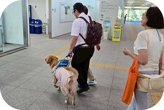 街を歩く松井さんとウパちゃんの後ろ姿